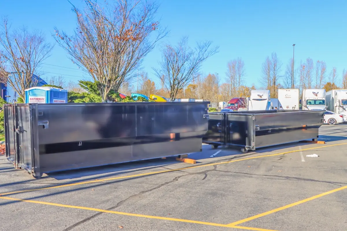 Professional dumpster rental service with roll-off container on residential driveway in Pittsfield